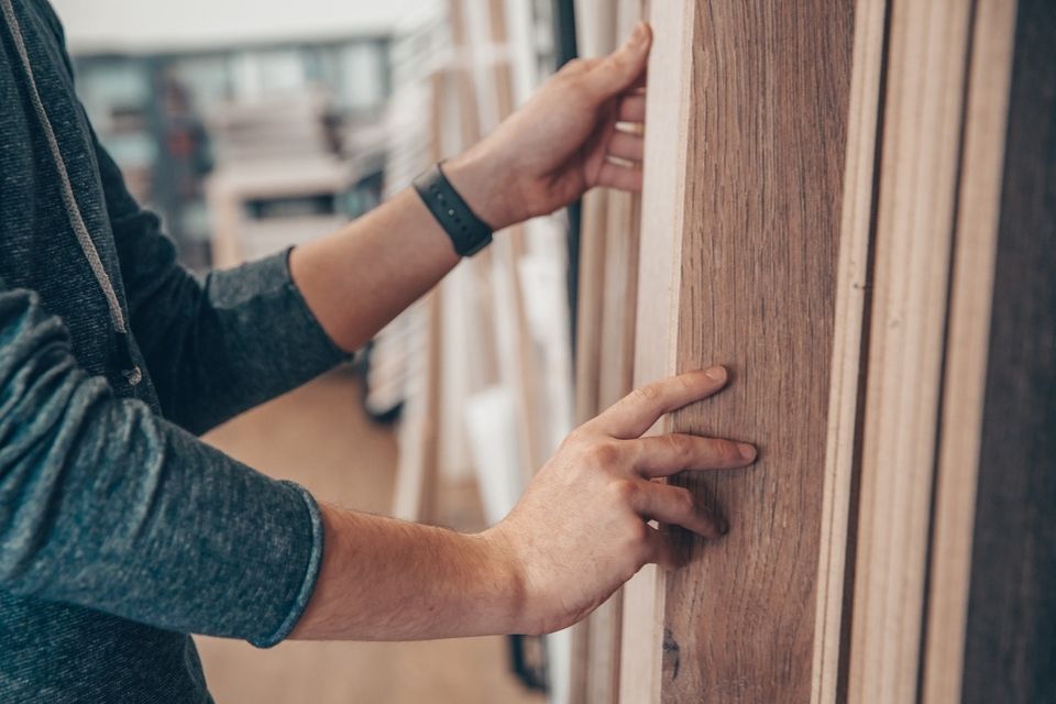 Man looking through flooring samples in a flooring store